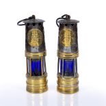 TWO SIMILAR 'HAILWOODS' MINER'S LAMPS, brass and steel with blue glass shades, 26cm high (2)