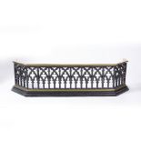 A LATE VICTORIAN CAST IRON AND BRASS FENDER, the facade of gothic arch form, 95cm wide