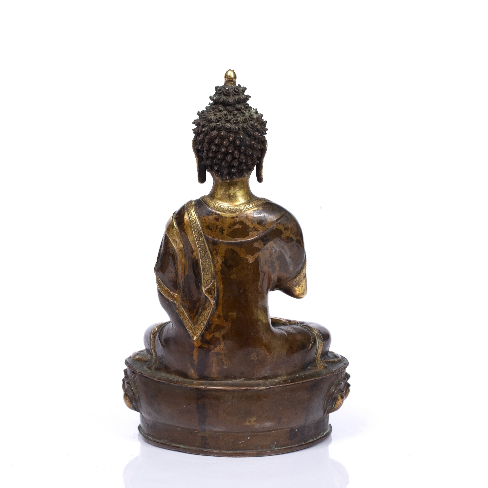 A NEPALESE GILT AND PATINATED BRONZE BUDDHA with original seal mark to base, 19th Century, 30cm - Image 2 of 3