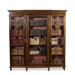 A MAHOGANY BREAKFRONT BOOKCASE IN SHERATON REVIVAL STYLE the moulded cornice with hand painted