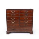 A GEORGE III MAHOGANY LIBRARY CHEST of narrow form, the moulded top above ten short and one long