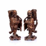 A PAIR OF CHINESE CARVED ROOT FIGURES, each in the form of a robed figure with glass inset eyes,