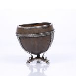 A COLONIAL WHITE METAL MOUNTED COCONUT CUP AND STAND, the bands with ribbed and beaded decoration
