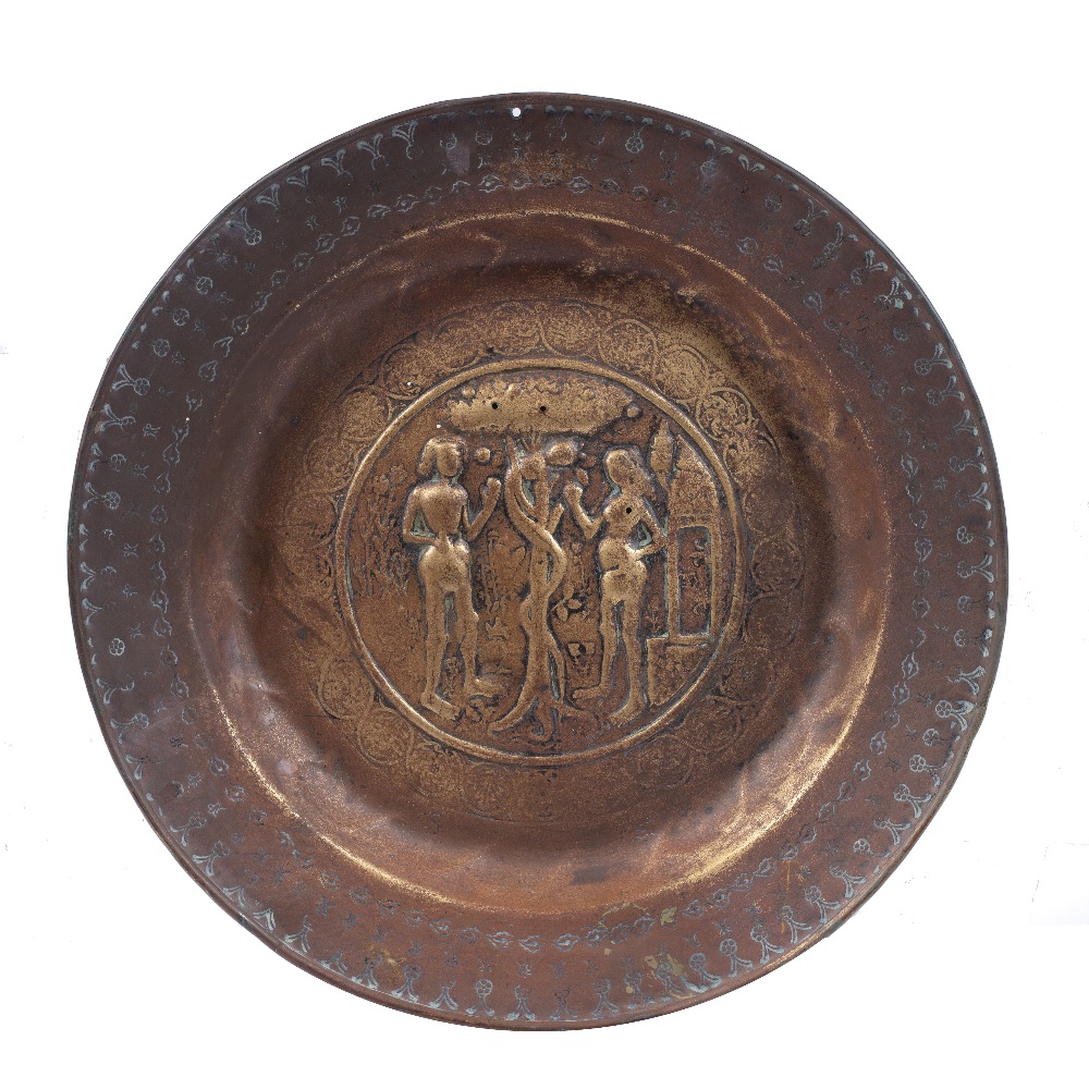 A NUREMBERG BRASS ALMS DISH the centre roundel embossed with Adam and Eve and serpent, Germany