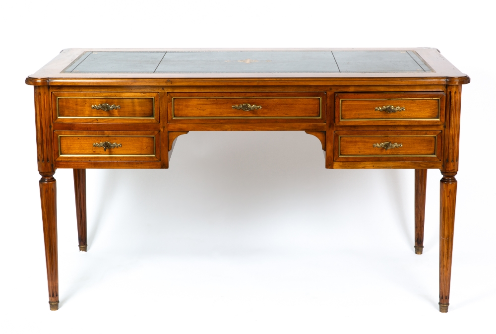 A continental hardwood desk with a green leather inset top, five drawers and turned and fluted legs,
