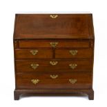 A George III Mahogany Bureau, the fall front opening to reveal short drawers and pigeon holes