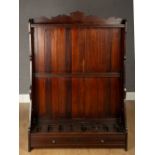 A dark stained wooden floor standing gun rack with eight recesses, 91.5cm wide x 27cm deep x 130cm