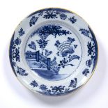 An antique Dutch Delft charger 35.5cm diameter Condition report: minor frits and losses to the glaze