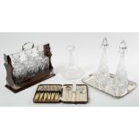 A modern silver plate mounted tantalus together with a pair of cut glass decanters, a silver