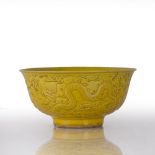 Yellow monochrome bowl Chinese, 19th Century the exterior relief moulded with a band of dragons