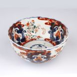 Imari bowl Japanese, 19th Century decorated with leaping rabbits beside stacked flowers divided by