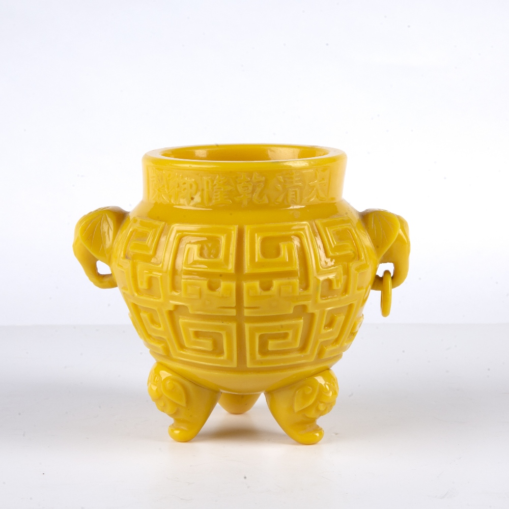 Yellow glass censer Chinese with the sides carved in low relief depicting archaic symbols, supported