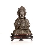 Bronze figure of Avalokiteshvara Chinese, late Ming with hands in mudra, the left hand holding a