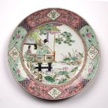 Famille rose charger Chinese, late 19th Century decorated in enamels with a girl holding a fan