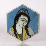 Qajar hexagonal tile Iran painted with the head of a girl, 20cm across Condition: two chips and wear