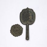 Two archaic bronzes Chinese comprising of a hand mirror engraved to the centre with two horses in