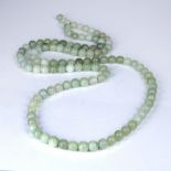 Long green hardstone necklace Chinese 182cm long Condition: worn, natural flaws and scratches, not