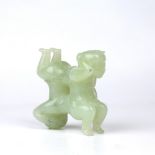 Hardstone puzzle piece Chinese depicting two boys climbing upon each other, 8.5cm across