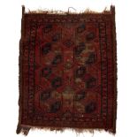 Bokhara red ground rug with eight elephant foot medallions, 107cm x 88cm Condition: worn and losses