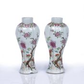 Pair of famille rose slender vases Chinese, 18th Century decorated in enamels depicting a rocky