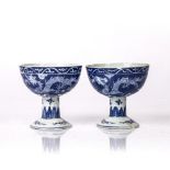 Pair of blue and white stem cups Chinese painted with dragons among clouds, the stems painted with