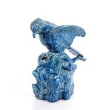 Glazed model of an eagle swooping on a dog Chinese the glazed blue monochrome group on a rocky base,