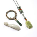 Jade belt buckle Chinese of dragon form,10cm, a green hardstone and jade pendant necklace and a jade