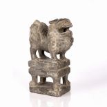 Carved stone model of a snow lion Chinese, 18th Century in the Ming style, the lion standing on a