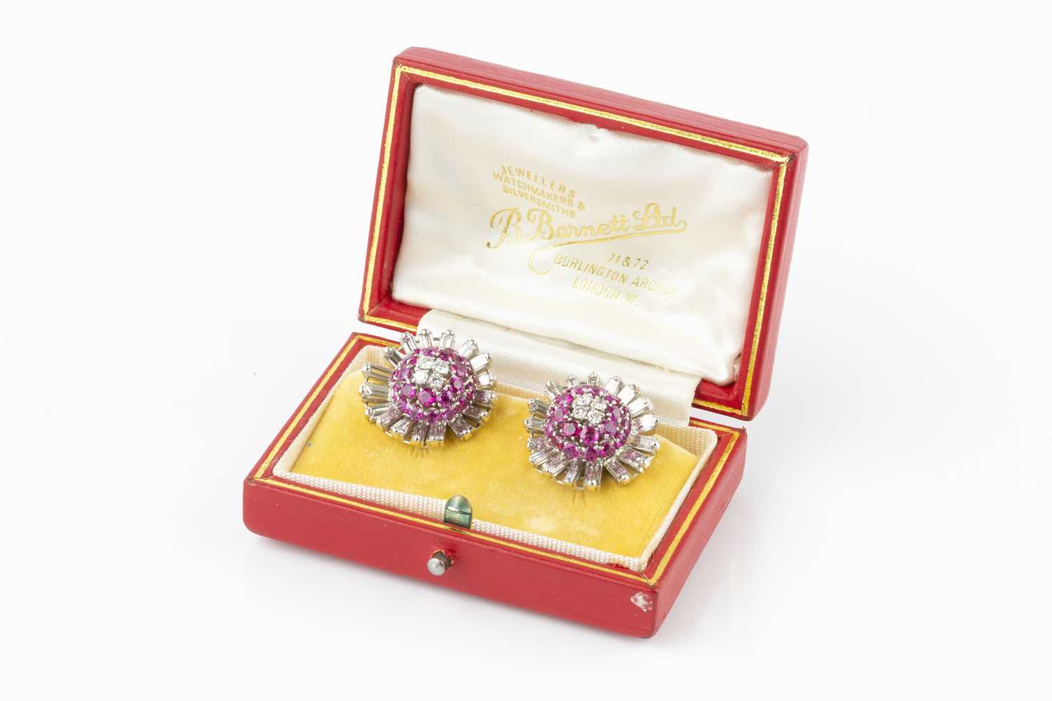 A pair of ruby and diamond cluster ear clips, each designed as a stylized flowerhead, centred with a - Image 3 of 3