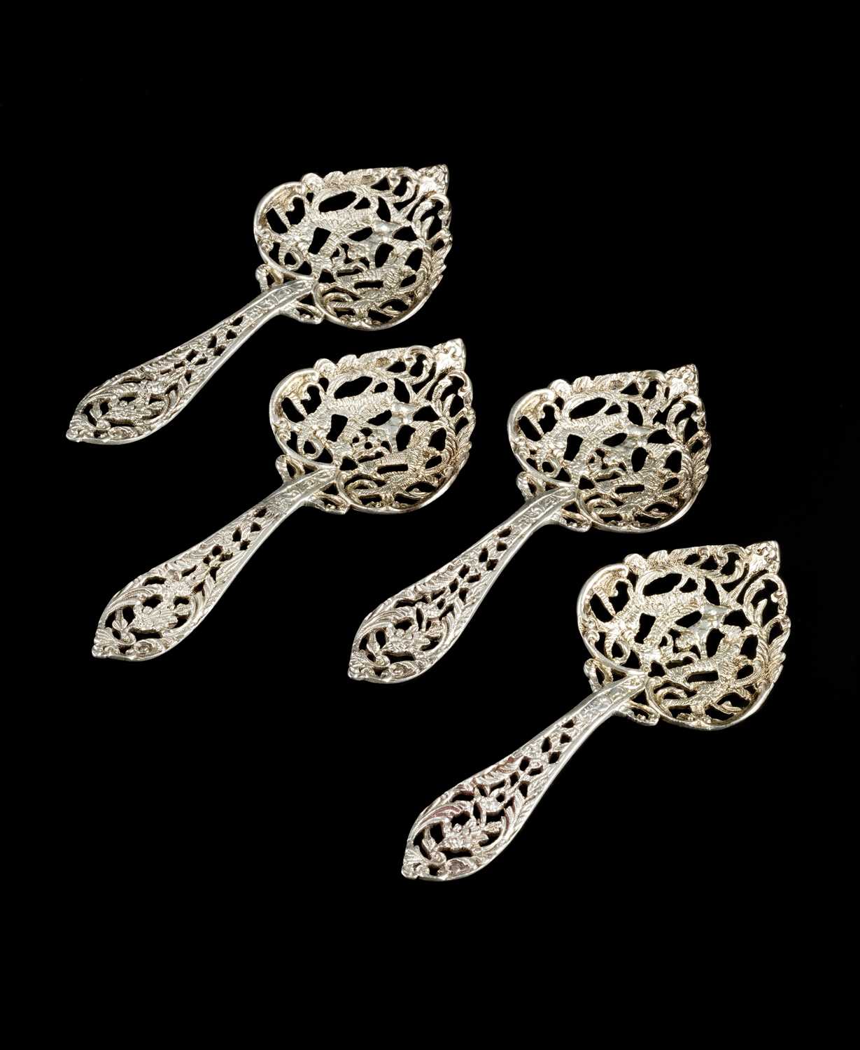 A set of four Edwardian Scottish silver ice-cream spoons, the handles and heart shaped bowls