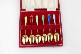 A set of six silver gilt and enamel coffee spoons, with vari-coloured enamel handles, by Adie Bros