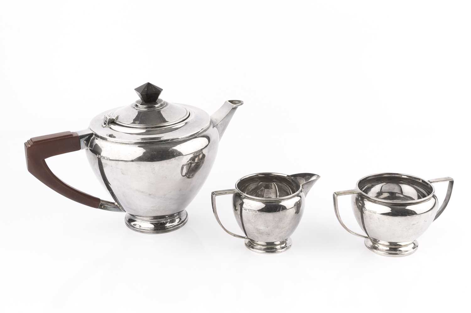 A silver three piece tea service, the teapot with angular composition handle and knop, by Mappin &