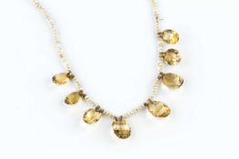 A citrine and seed pearl fringe necklace, the fringe of graduated oval mixed-cut citrines