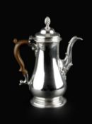 An early George III silver coffee pot, of baluster form, the hinged domed cover with spirally fluted