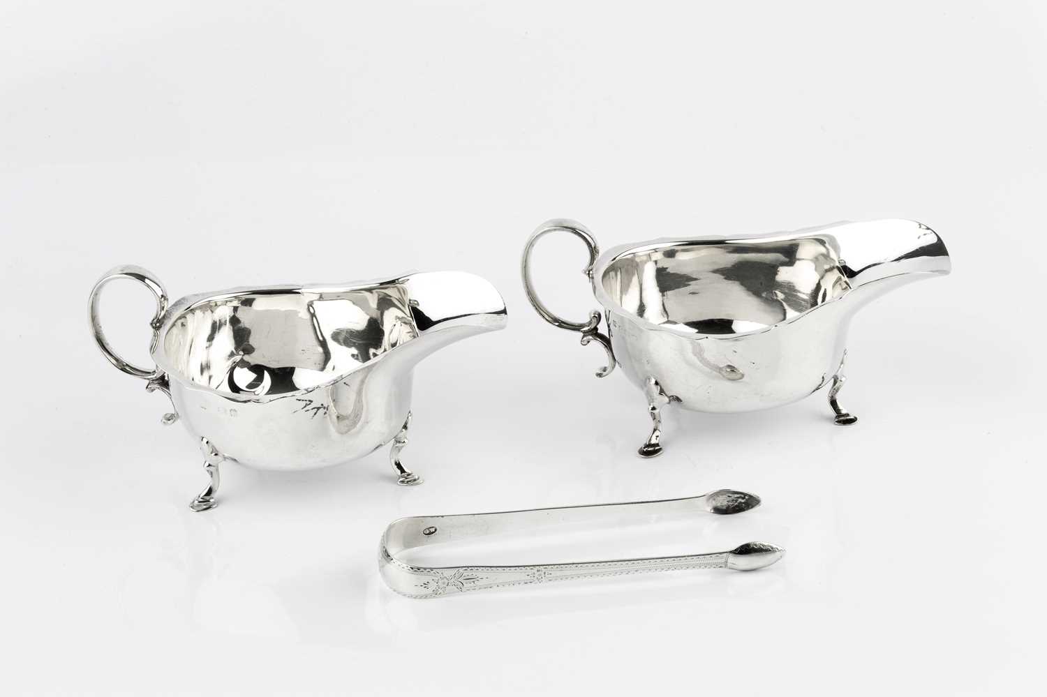 A pair of silver sauceboats, with scroll handles and pad feet, by Martin, Hall & Co, Birmingham 1922