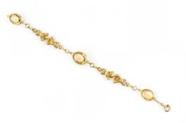 A citrine set panel bracelet, of fancy-link design, the trio of oval mixed-cut citrines in collet