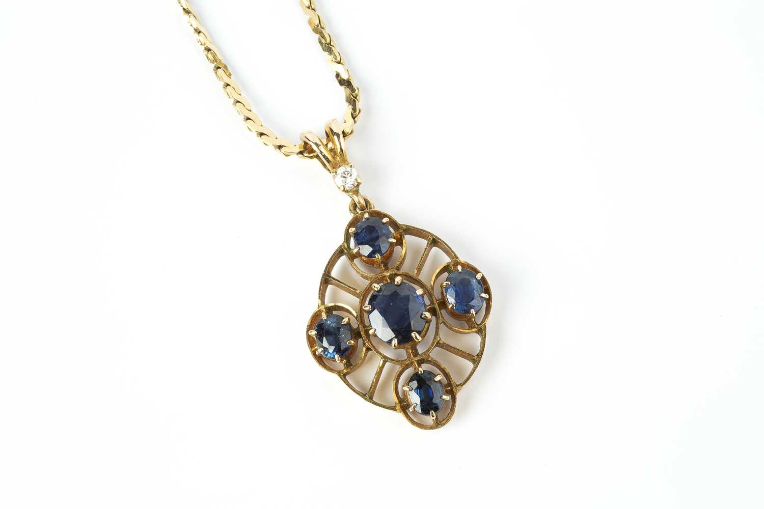 A sapphire and diamond set pendant on chain, the oval openwork pendant with a cluster of graduated