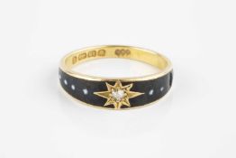 A late Victorian diamond and enamel memorial ring, the tapered black enamel hoop with beaded white