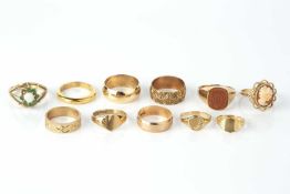 A collection of rings, comprising two 9ct gold engraved wedding bands, three further 9ct gold