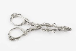 A pair of William IV silver sugar nips, decorated with entwined foliage with flowerhead pivot and