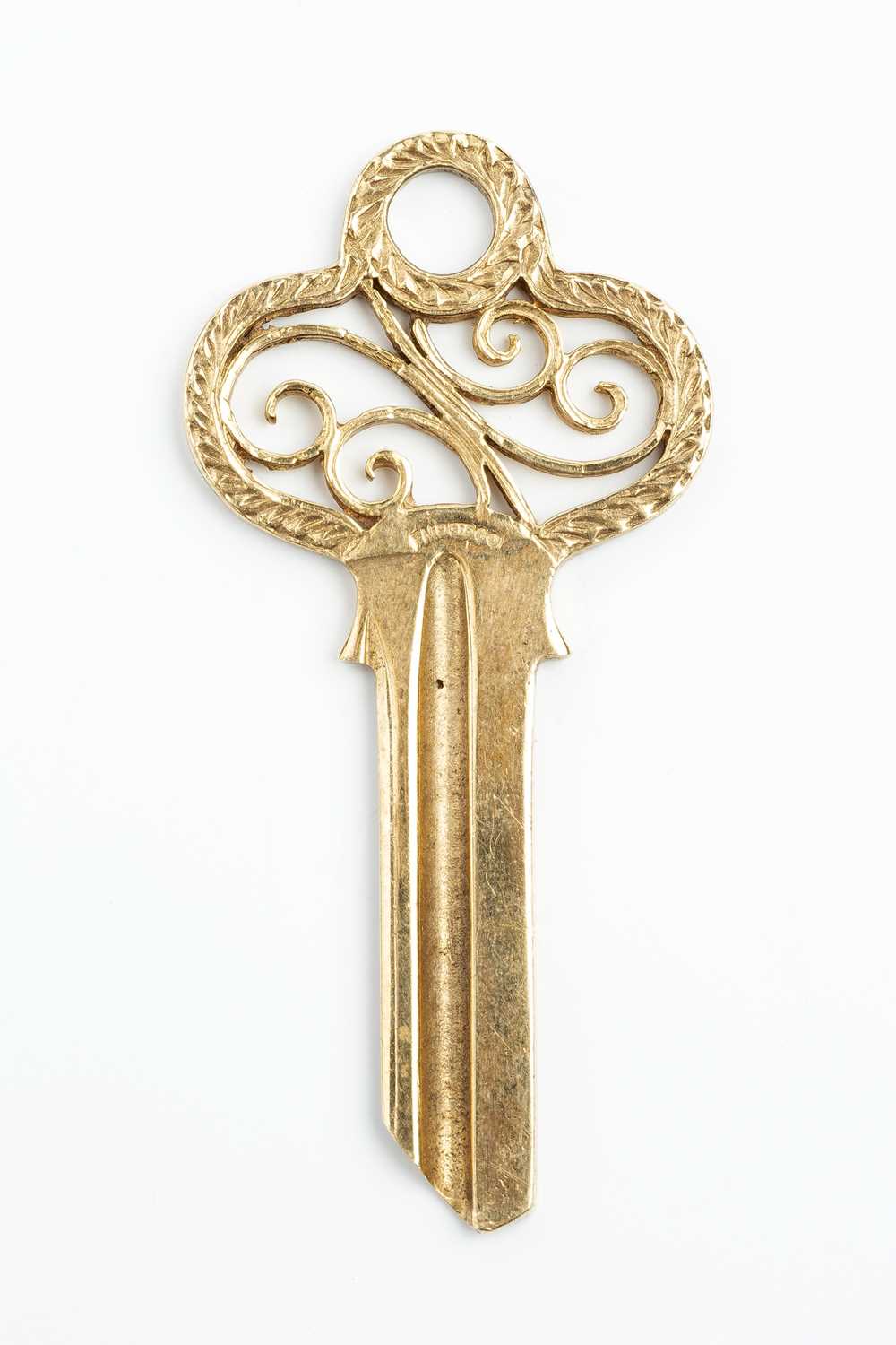 A 9ct gold key, the openwork scrolled surmount with foliate border, hallmarked for London 1965, - Image 2 of 2