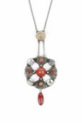 An Arts and Crafts pendant necklace, the openwork panel highlighted with a cluster of red and