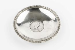 An Indian sterling silver circular dish, with lobed rim and inset with a USA dollar coin, 12.5cm,