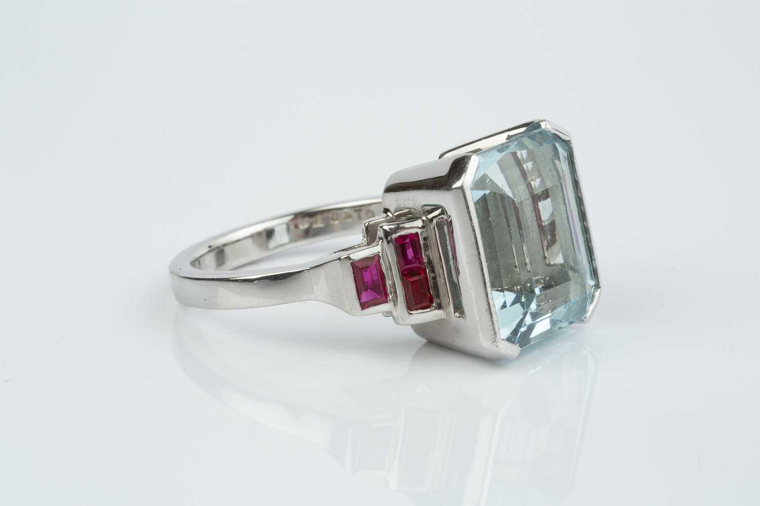 An aquamarine and ruby dress ring, the octagonal step-cut aquamarine in raised part-collet - Image 3 of 3