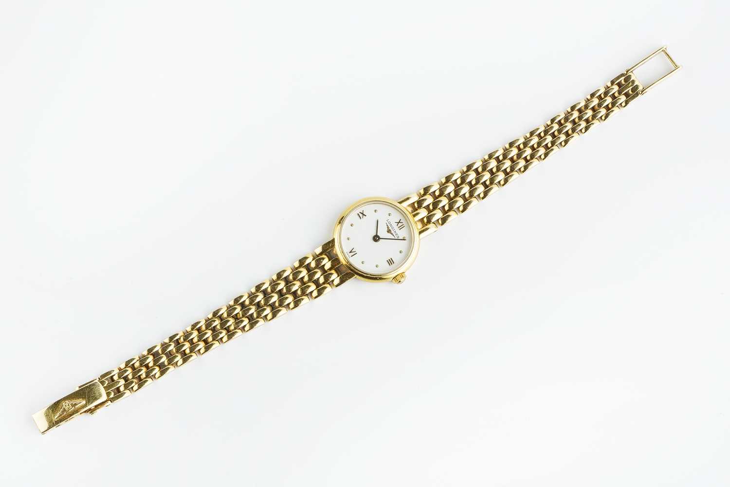 A lady's 18ct gold bracelet watch by Longines, the circular white dial with gilt Roman numeral