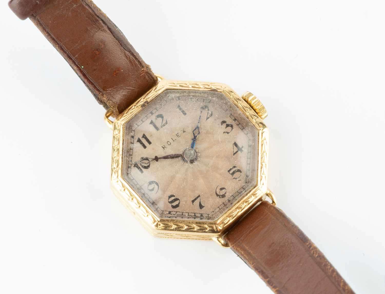 A lady's 18ct gold cased wristwatch by Rolex, the octagonal silvered dial with stylized Arabic