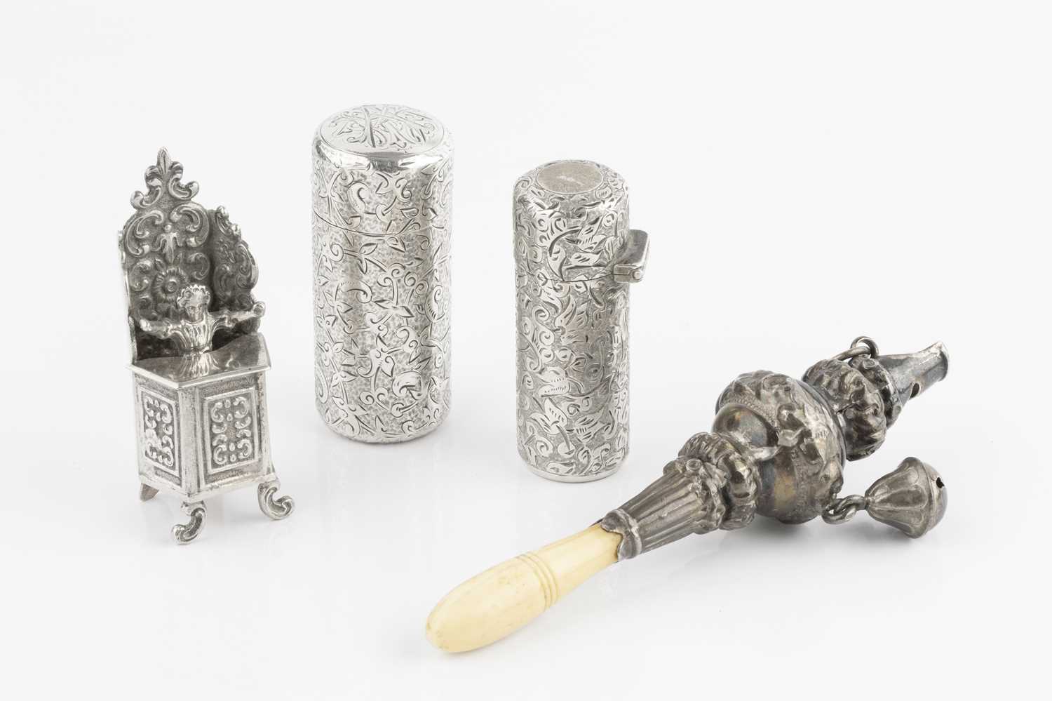 A late Victorian silver cylindrical scent bottle, engraved with stylised scrolling foliage and