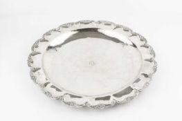 A Peruvian silver charger, the lobed border with stylised flowerhead and scroll decoration,