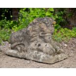 A cast reconstituted stone small sculpture of a resting lion, 63cm long x 39cm high overallCondition