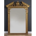 A large George III gilt pier mirror with breakarch pediment, central shield motif flanked by
